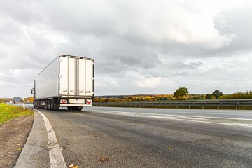 Fototapeta na wymiar Motion blurred trucks on highway. Logistics and transportation