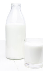 A bottle and glass of milk isolated on a white background