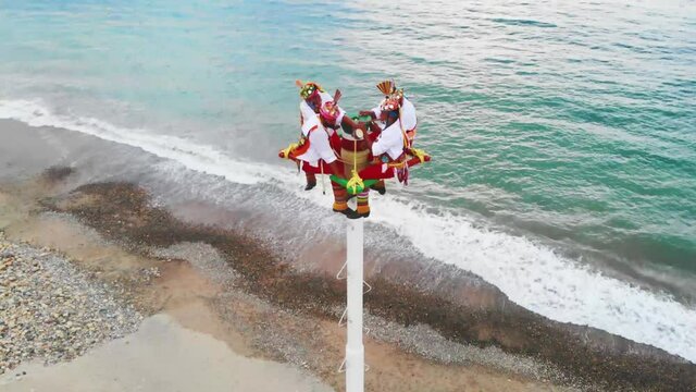 Papantla flyers in top of the pole, ready to perform native Mexican pole dance for the God Xipe Totec
