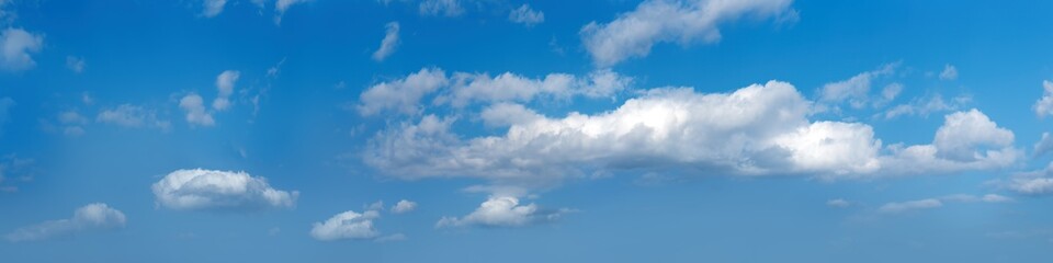Obraz premium Ultra wide panorama of afternoon blue sky with white clouds.