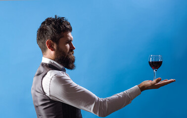 Sommelier with wine glass. Tasting alcohol. Red wine. Man with alcohol. Bearded man with glass of...