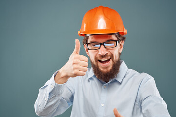 Cheerful man in orange hard hat shirt gesturing with hands work construction engineer