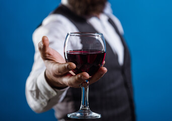 Wine glass close up. Bearded man with glass of wine. Tasting alcohol. Red wine. Man with alcohol. Man drinks wine. Man with Bordeaux.