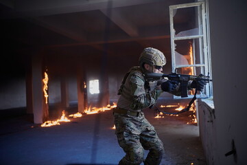 soldier in action near window changing magazine and take cover