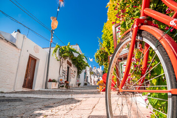 Classical bicycle parked in the middle of the old town surrounded with flowers and trafitional...