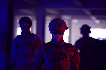 soldier squad team walking in urban environment colored lightis