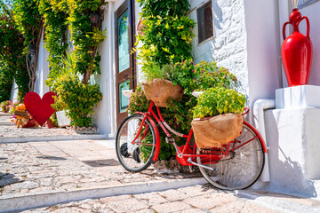 Classical bicycle parked in the middle of the old town surrounded with flowers and trafitional...
