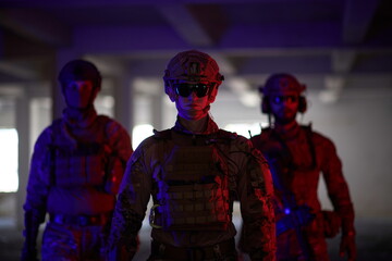 soldier squad team walking in urban environment colored lightis