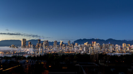 Blue Hour after the Sun has set over the Skyline of Downtown Vancouver, British Columbia, Canada. Viewed from the South Shore of Falls Creek