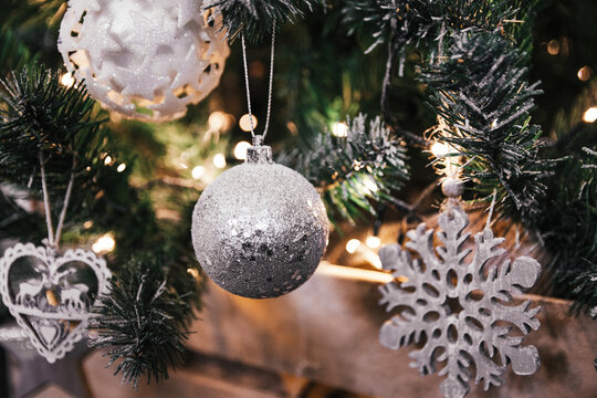 Closeup of beautiful silver ornaments on a festive Christmas tree