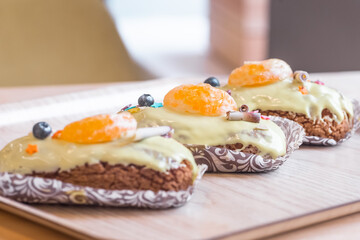 three eclairs with custard in a bakery