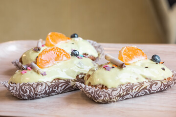 three eclairs with custard in a bakery