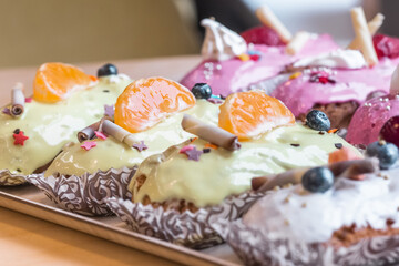 three eclairs with custard in a bakery