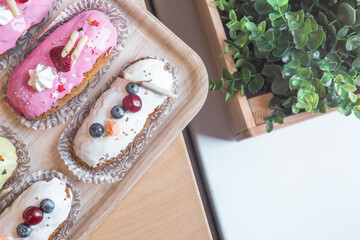 Fototapeta na wymiar three eclairs with custard in a bakery
