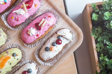 three eclairs with custard in a bakery