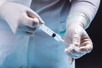 female doctor holding syringe and prepare for making vaccine or drug injection. medicare and...