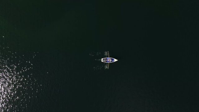 Birds Eye View of rowboat on a lake, couple, shipping, landscape, nature, love, relax, dinghy, static, lovers, aerial drone shot