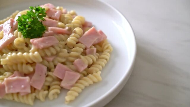 spirali or spiral pasta mushroom cream sauce with ham - Italian food styl