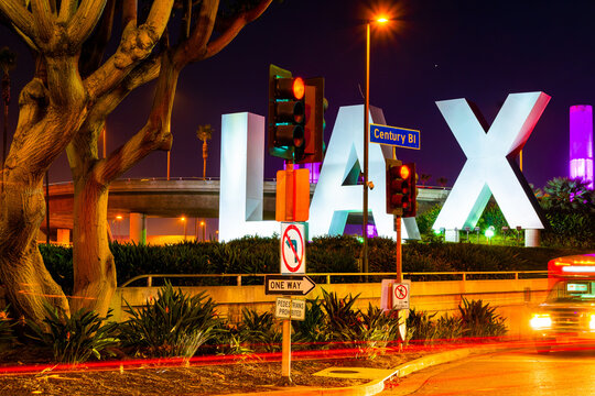 Los Angeles, California - October 11 2019: LAX Airport sign at night in Los Angeles California. Iconic bold lettering landmark on the city streets approaching the International Airport.