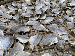 dry salty nile tilapia fish on bamboo floor