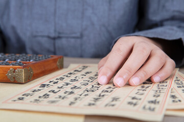 Close-up shot of Chinese medicine doctor's hand on prescription