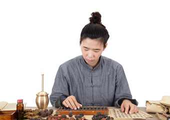 Young Chinese doctors of Chinese medicine are using traditional abacus beads to calculate the amount of medicine on the prescription