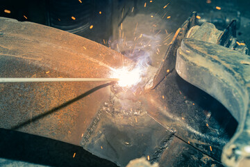 Welder Welding Bottom Car Chassis by Electric Welding Torch in Zoom View in Vintage Tone