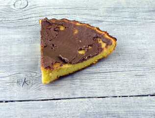 a piece of chocolate cake lies on a white background