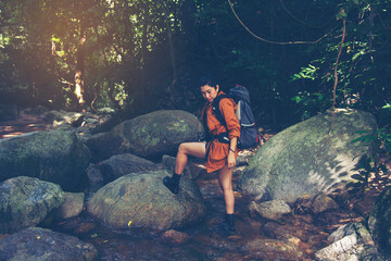 Hiker with backpack relaxing young woman hiking holiday, wild adventure.