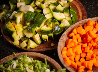 Closeup shot of chopped carrots, greenery, and cucumber