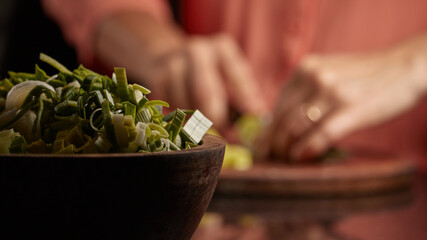 Selective focus shot of chopped green onion in a bowl