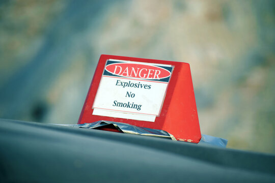 Sign on top of a car with the English text: Danger, Explosives, No Smoking
