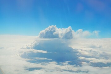 Fototapeta premium Clouds and blue sky view from airplane window
