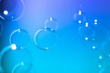 Fototapeta na wymiar Abstract, Clear transparent bubbles float on dark blue texture background.