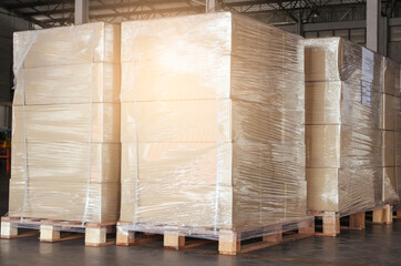 Cargo shipment boxes. Stack of  package boxes wrapping plastic film on pallet rack. Warehouse storage. Manufacturing and warehousing.