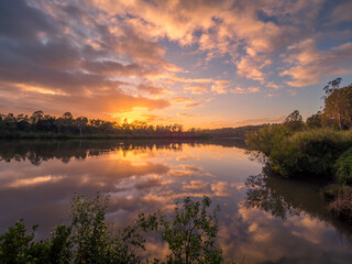 Beautiful Riverside Sunrise with Cloud Reflections