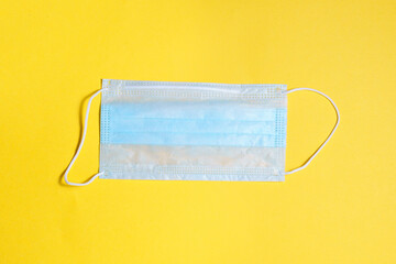 Medical protective mask, on a yellow background. Covid-19 antivirus protection kit. the view from the top