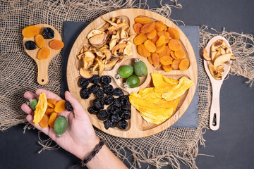 dried fruits and on the background of black stone or slate. The concept of a healthy dessert.