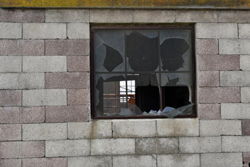The broken windows on a brickwork wall
