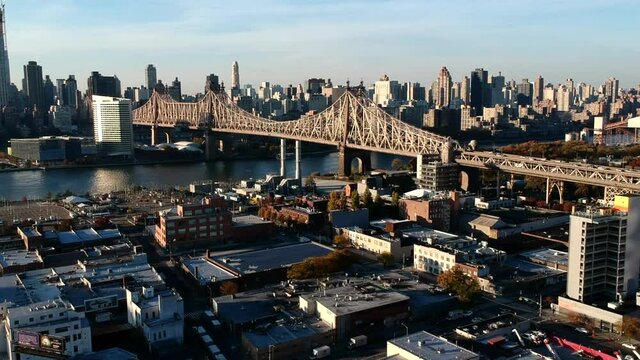 Queensboro Bridge Over East River And Roosevelt Island At Sunset In New York City, USA. - aerial drone descend
