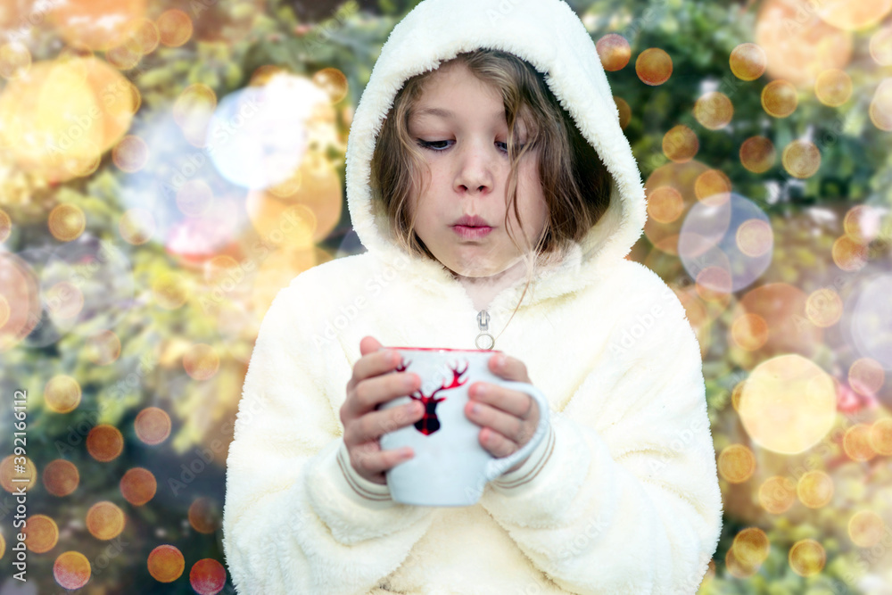 Wall mural gorgeous little girl drinking hot drink under the christmas tree