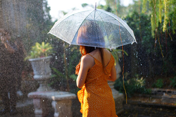 Beautiful womanstanding holding an umbrella in the rain