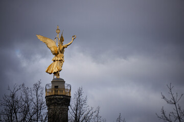 Fototapeta premium The Siegesallee, the historical victory column in a cloudy day in Berlin, Germany, back view