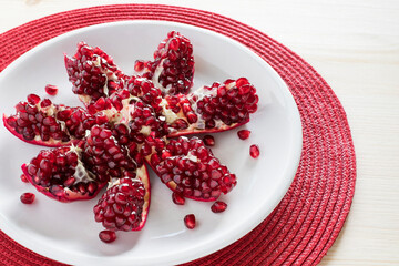 Pomegranate on plate on table.  Healthy snack and natural vitamins concept. 