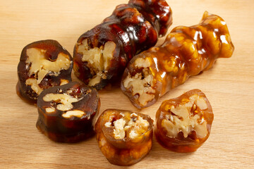 Walnuts on a string dipped in starch grape molasses. Churchkhela. Walnut sujuk.