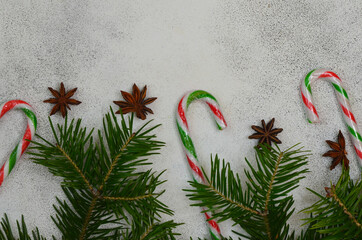christmas background, frame, card, mock up, copy space, spruce branch and sweet lollipops top view flat lay still life, anise star seasoning