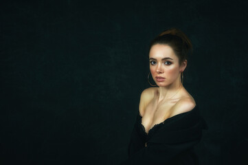 Portrait of a young beautiful woman in a Studio on a dark background