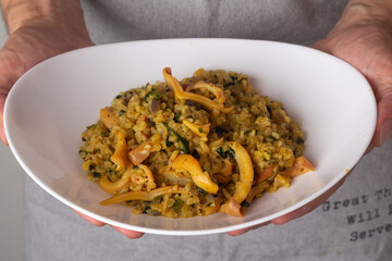 bulgur with seafood in a white plate
