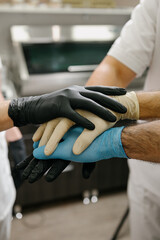 Gloved hands of medics working as a team