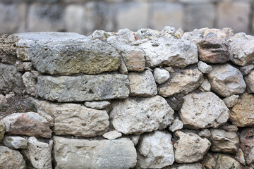 Stones in the wall of the house as an abstract background.